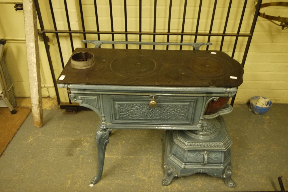 A late 19th/early 20th century French enamelled stove with griddle plate, drop down side panels