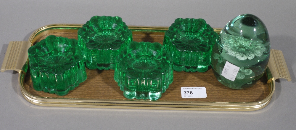 A 19th century green glass dump, together with a set of four green glass furniture rests