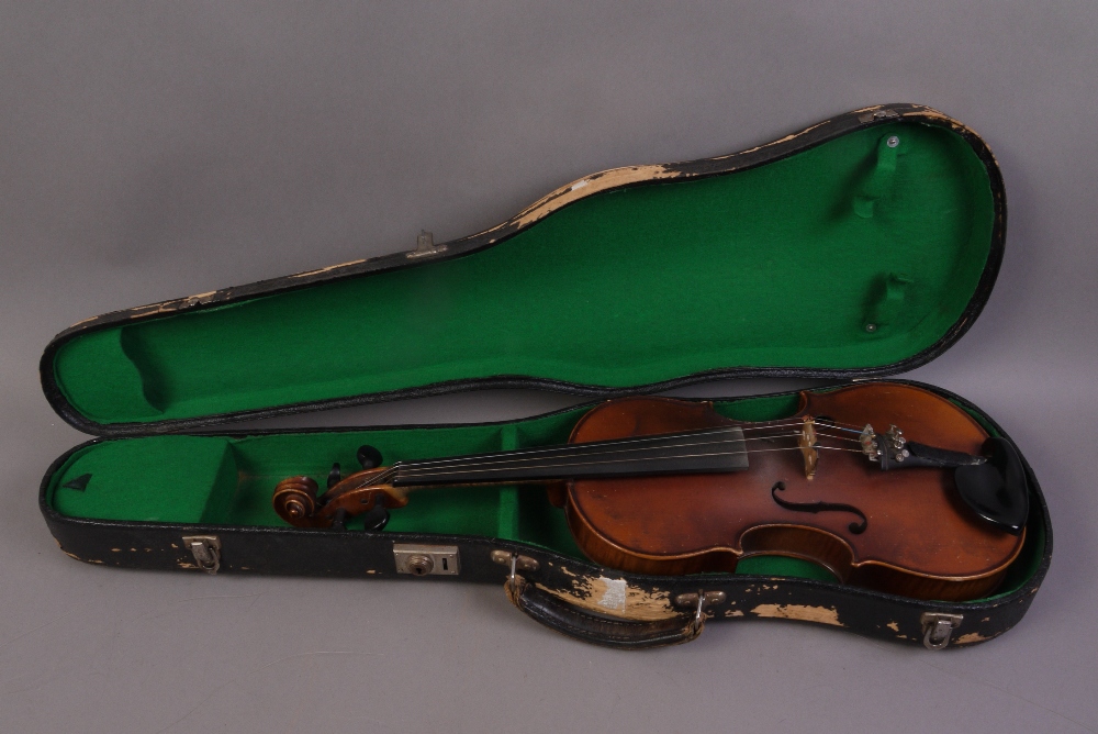 A Czechoslovakian violin after Nicolans Amatus, labelled first half 20th century, the one piece back