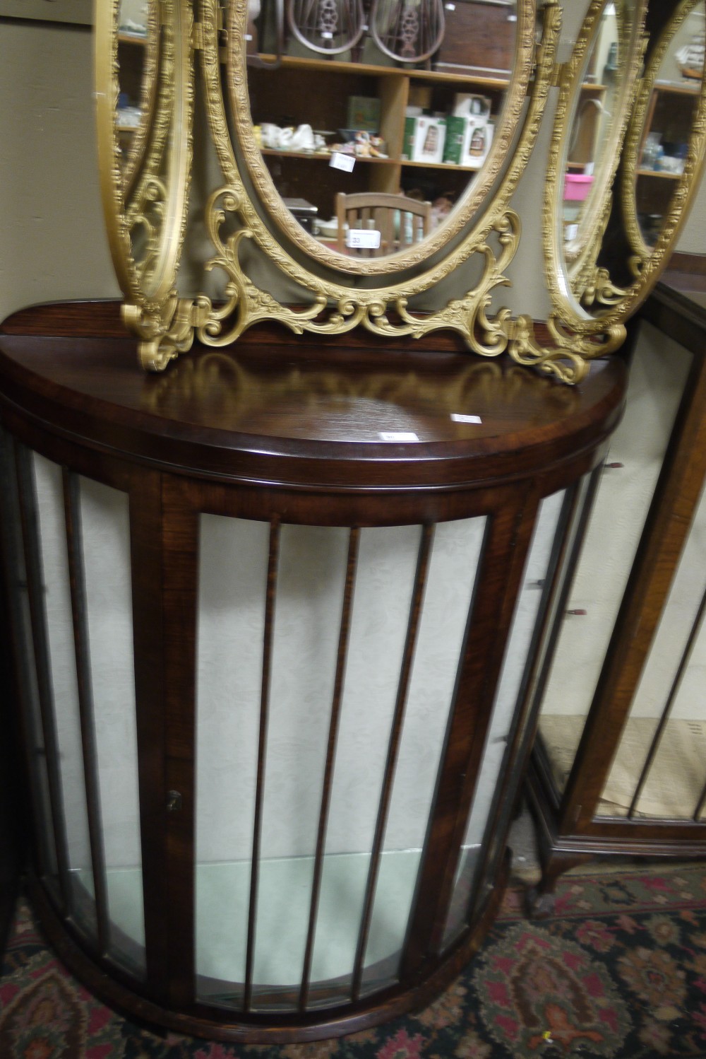 An inter-war period mahogany glazed bow front display cabinet in the art deco style with two glass