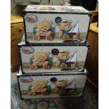 A set of three graduated toy trunks prin