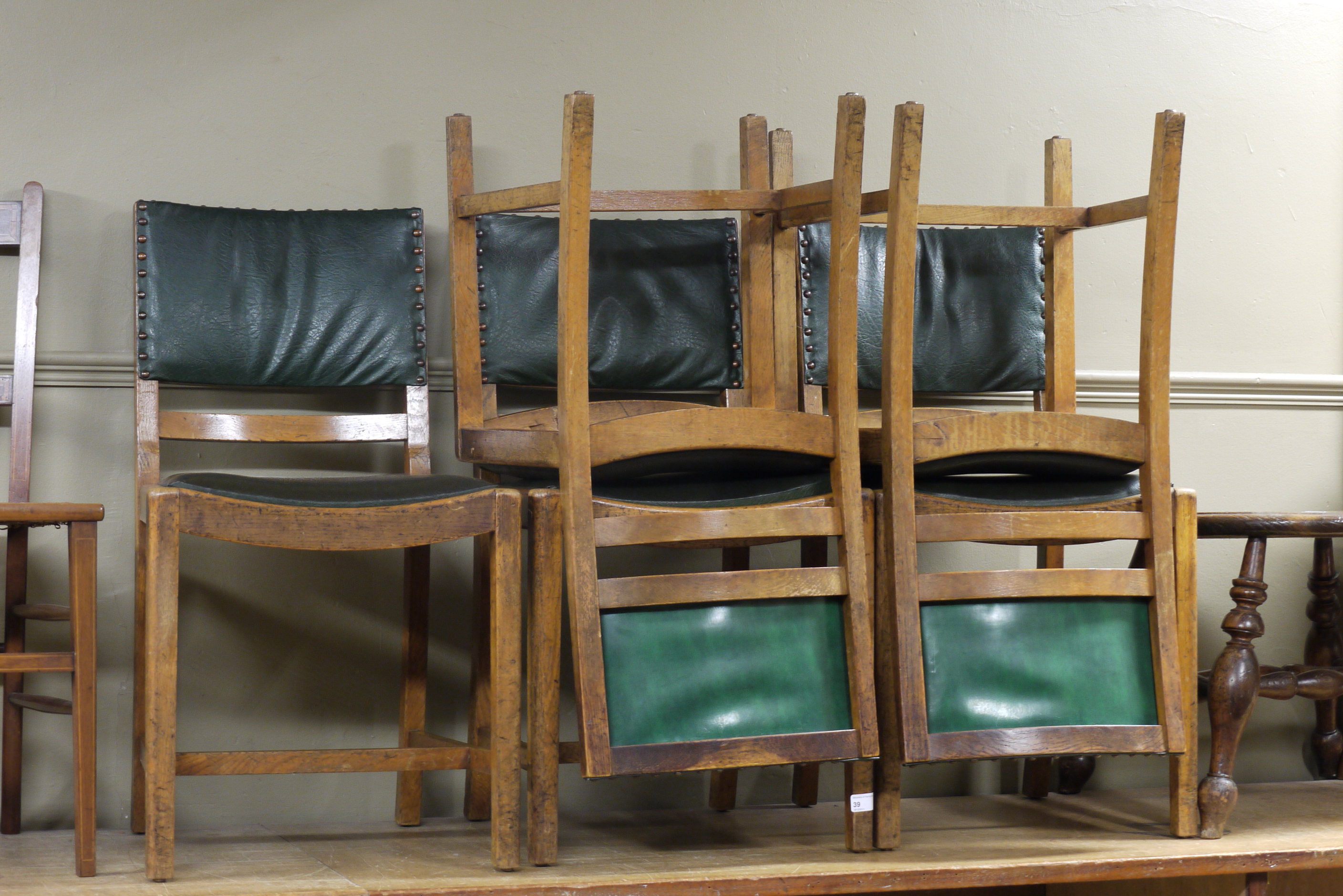 A set of five oak dining chairs with lea