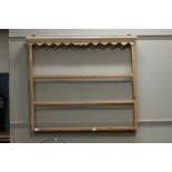 A pine wall rack of three shelves