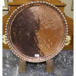 A large copper plaque of circular outlin