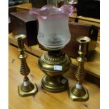 A brass oil lamp with frosted and cranbe