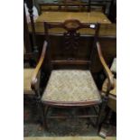 An Edwardian open arm chair with pieced