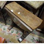 An oak oval drop leaf coffee table on tw