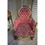 A Victorian walnut armchair having a mou