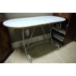 A metal garden patio table on scrolled l