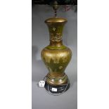 A green and gold baluster table lamp on