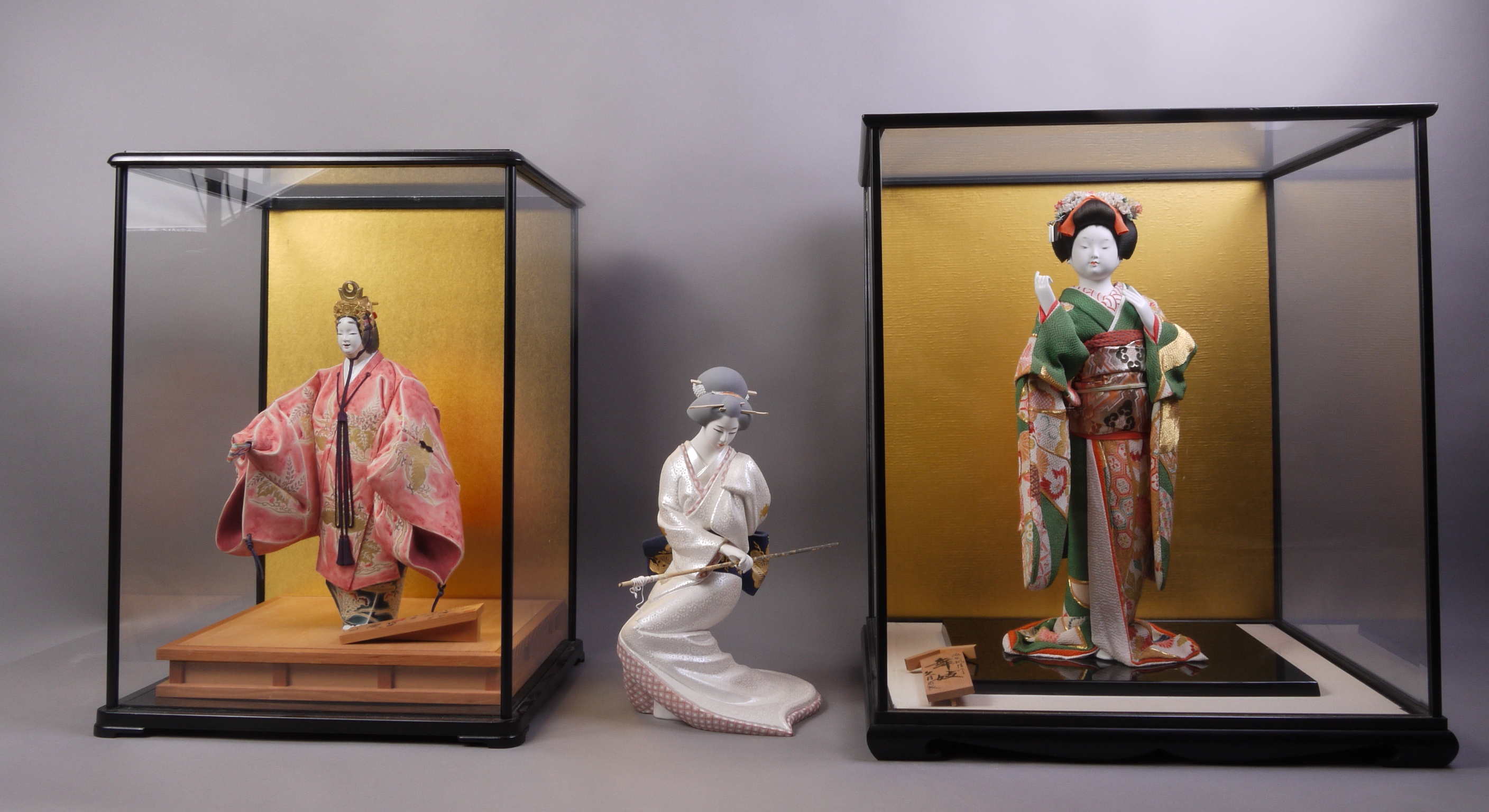 Three Japanese Kyugetsu porcelain dolls,