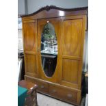 A 1920s mahogany wardrobe, having an arc