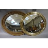 A brass framed oval wall mirror together