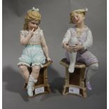 A pair of Bisque figures of a girl and a