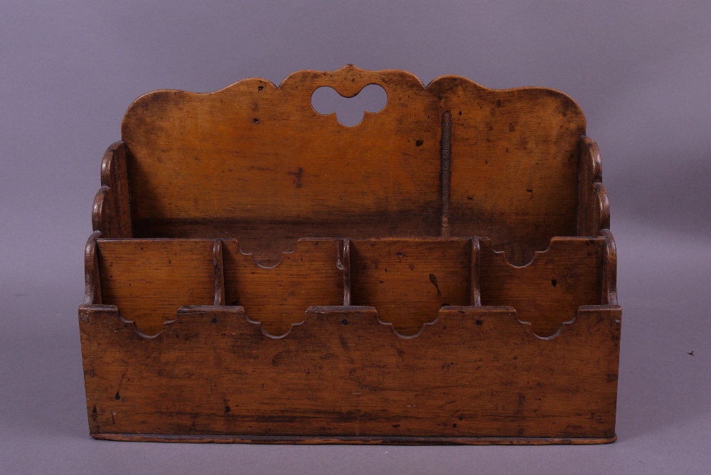 A LATE VICTORIAN OAK DOUBLE-SIDED STATIONERY RACK, the end panels of shaped and arched form, the