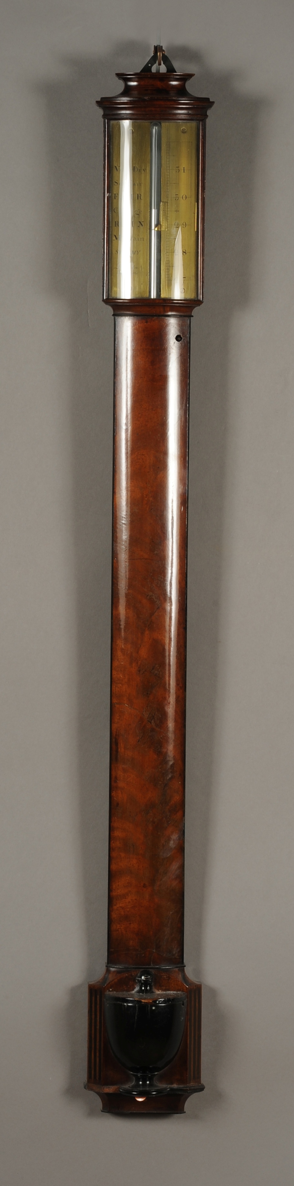 A GEORGE III FIGURED MAHOGANY AND EBONISED BOWFRONT STICK BAROMETER, the brass dial signed 'Ramsden,