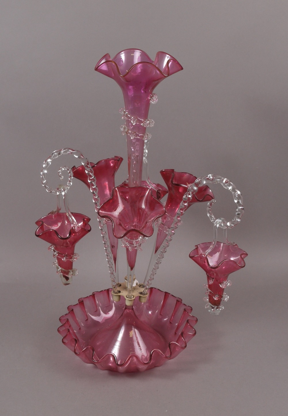 A VICTORIAN CRANBERRY AND CLEAR GLASS EPERGNE, the dished base of shaped circular form with