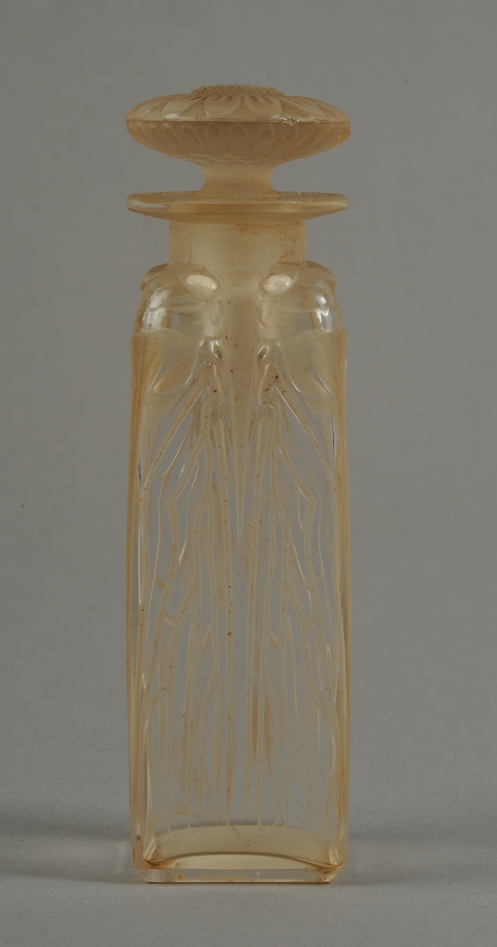 A LALIQUE 'QUATRE CIGALES' PATTERN SCENT BOTTLE AND STOPPER, of square section, moulded with