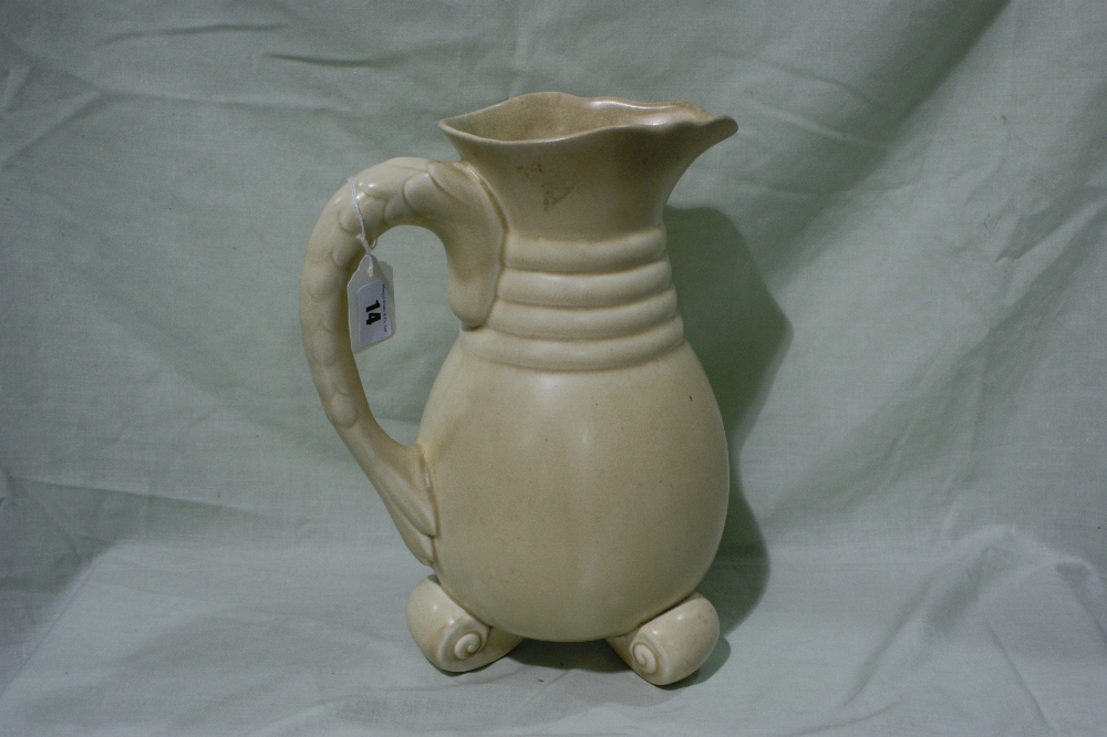 An Art Deco Pottery Water Jug, Scrolled Three Footed Base And Moulded Handle, 12"" High