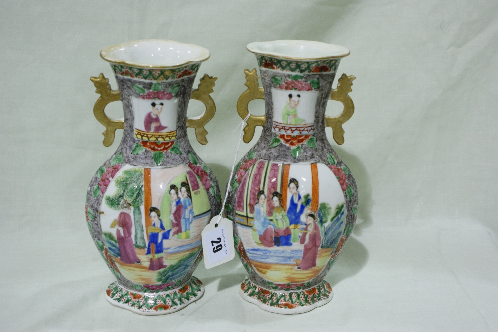 A Pair Of 19th Century Cantonese Two Handled Vases, Oval Based And Decorated With Panels Of Figures