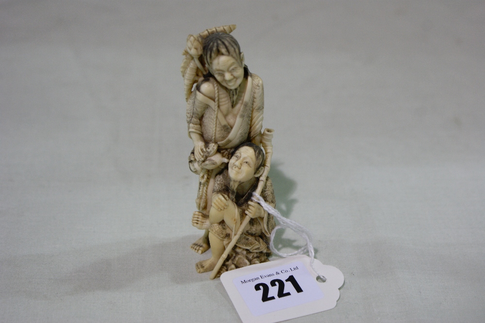 A Finely Carved 19th Century Ivory Group Of Two Oriental Figures, One Standing And One Sitting, The