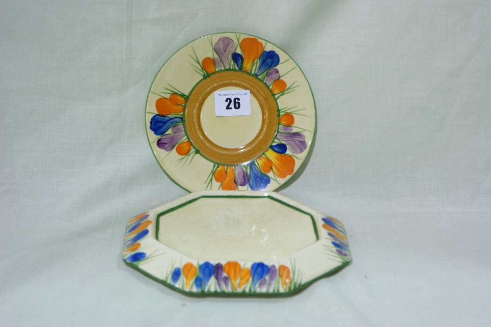 A Clarice Cliff Crocus Pattern Tea Pot Stand Together With A Circular Crocus Pattern Saucer