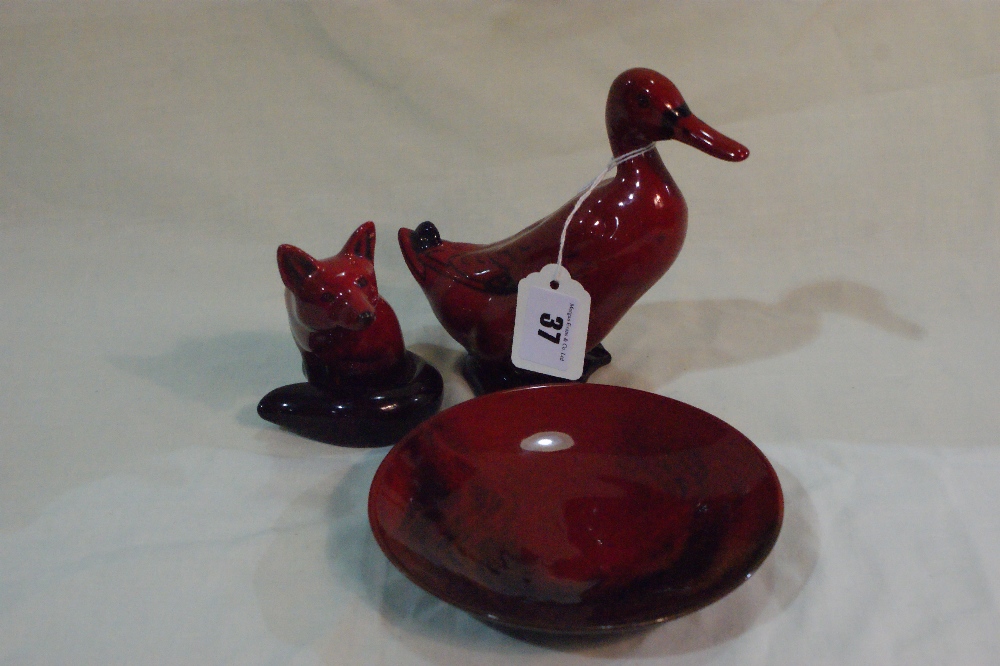 A Royal Doulton Flambe Model Of A Standing Duck Together With A Seated Fox With Curled Tail And A