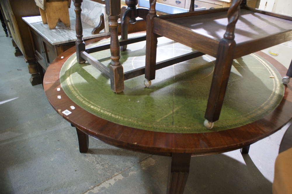 A Circular Topped Mahogany Finish Writing Table With Leather Inlay