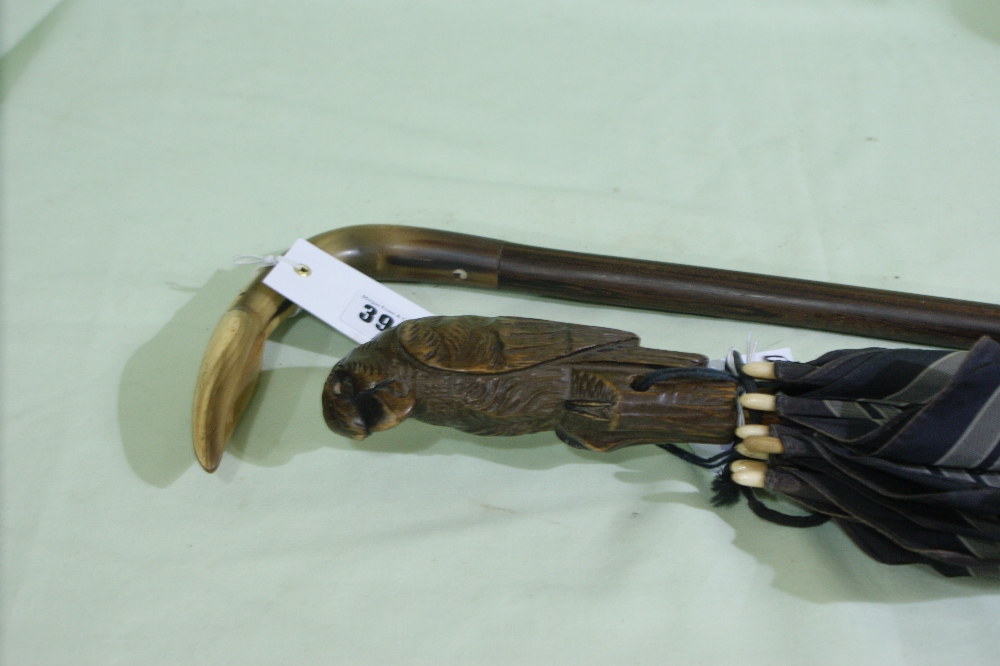 A 19th Century Rosewood And Horn Handled Walking Stick Together With A Black Forest Type Carved