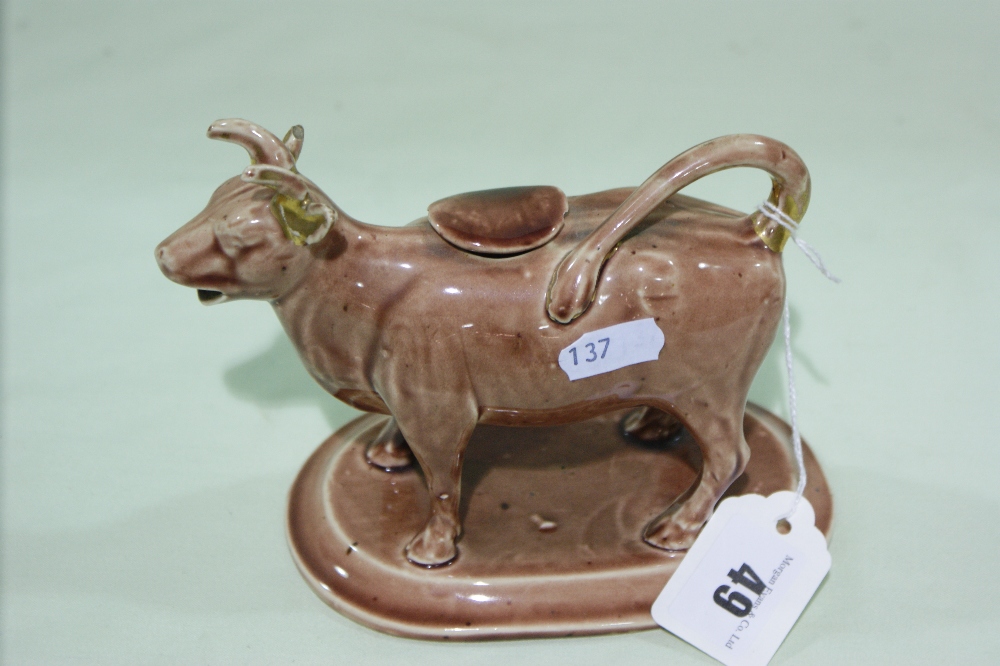 A Staffordshire Pottery Glazed And Gilt Decorated Cow Creamer