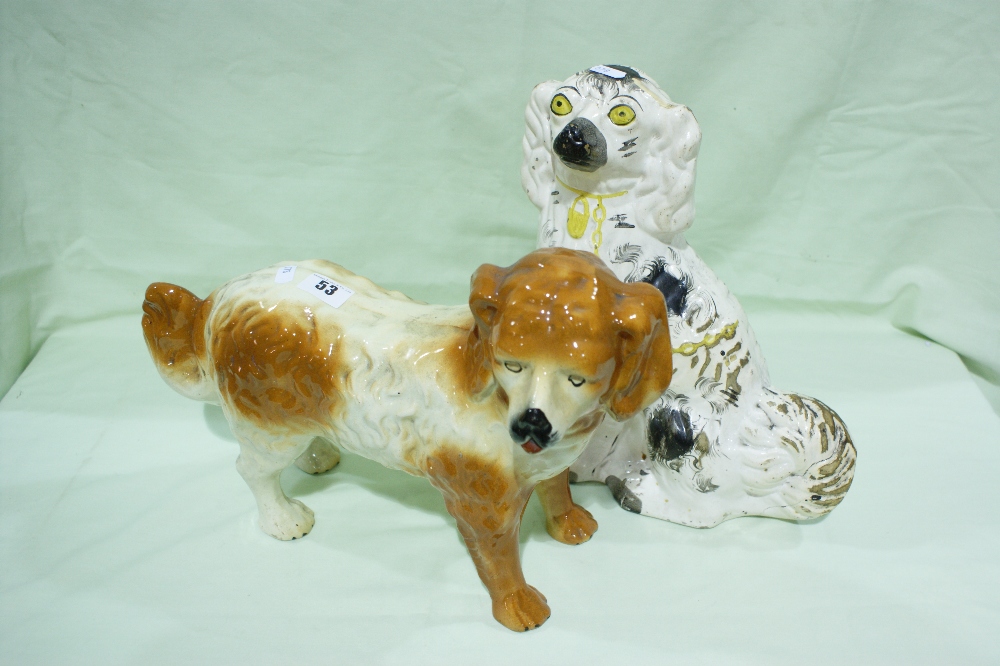 A Staffordshire Pottery White Seated Dog Together With A Staffordshire Pottery Standing Dog