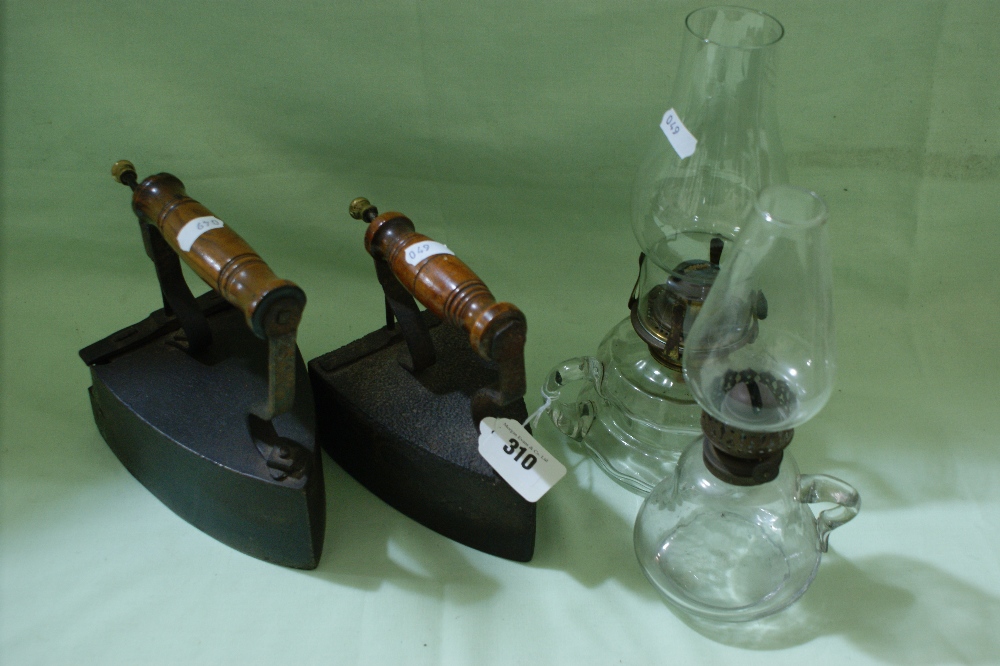 Two Glass Bedroom Oil Lamps Together With Two Antique Flat Irons