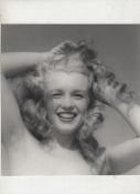 Marilyn Monroe original bw photograph showing Marilyn hs her hands in her hair and smiling towards