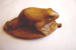 Japanese art ? netsuke finely carved netsuke of a frog on a lily pad. Hard wood is used to obtain
