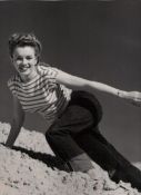 Marilyn Monroe original bw photograph showing Marilyn in jeans and a striped t-shirt on the side of