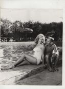 Marilyn Monroe original bw photograph showing Marilyn in swimming costume sitting by the side of a