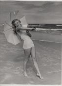 Marilyn Monroe original bw photograph showing Marilyn in swimsuit standing with parasol and smiling