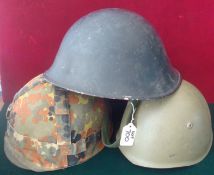 Selection Military Helmets: Three steel Helmets all having there Liners and Straps to include como