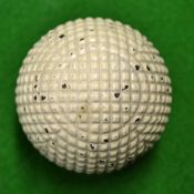 Unnamed and fine square mesh moulded guttie golf ball c1890 – retaining most of the original white