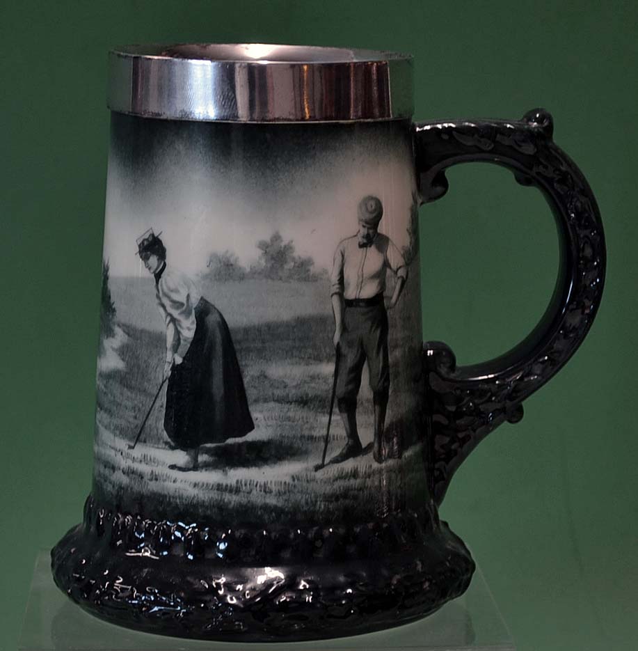 Fine Lenox ceramic and silver rimmed golfing tankard c1900 – decorated with a lady putting watched