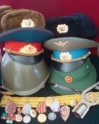 Collection of Russian Militaria: To include Steel Helmet, Two Peak Caps, Two Fur Hats, Pith