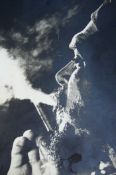 Che Guevara bw photograph of Che showing the side of his face in close up blowing smoke from a
