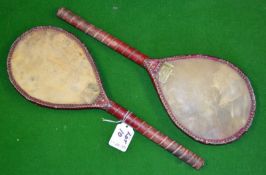 Pair of Vic small Battledore rackets â€“ both with vellum faces, red trim, remains of the original