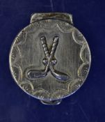 Small white metal pill box decorated with crossed golf clubs and balls in relief â€“ hinged lid