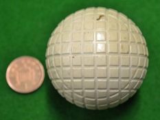 A fine unnamed Clent over size square mesh pattern golf ball â€“ appears unused retaining all the