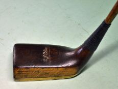 R J Gibson Gassiat style dark stained persimmon socket head putter with brass sole plate held by 8