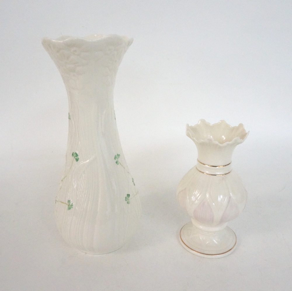 TWO BELLEEK PORCELAIN VASES
one of shaped form decorated with daises, 27cm high, the other with a