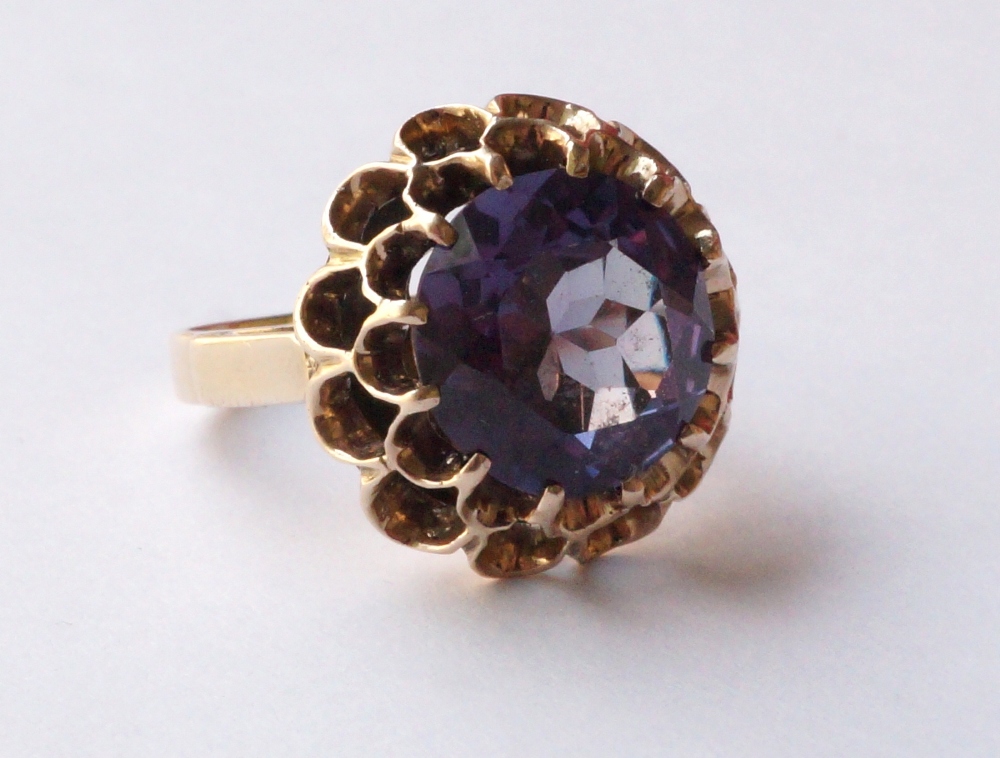MYSTIC TOPAZ SINGLE STONE DRESS RING
the large central round brilliant cut topaz in pierced setting,