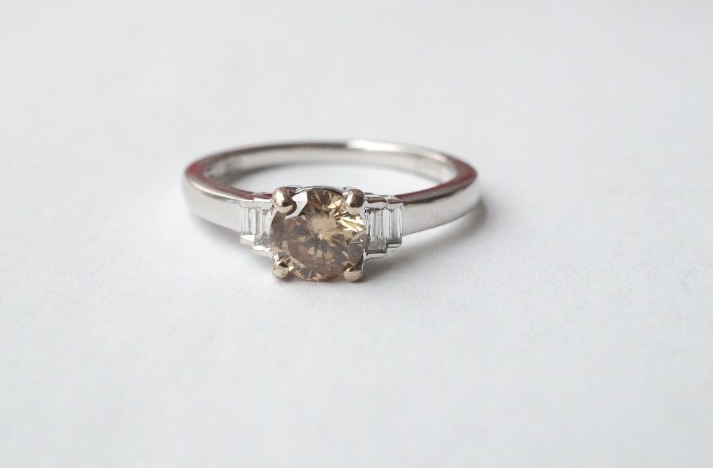 COGNAC DIAMOND RING
the central cognac diamond approximately 0.62cts flanked by baguette cut white