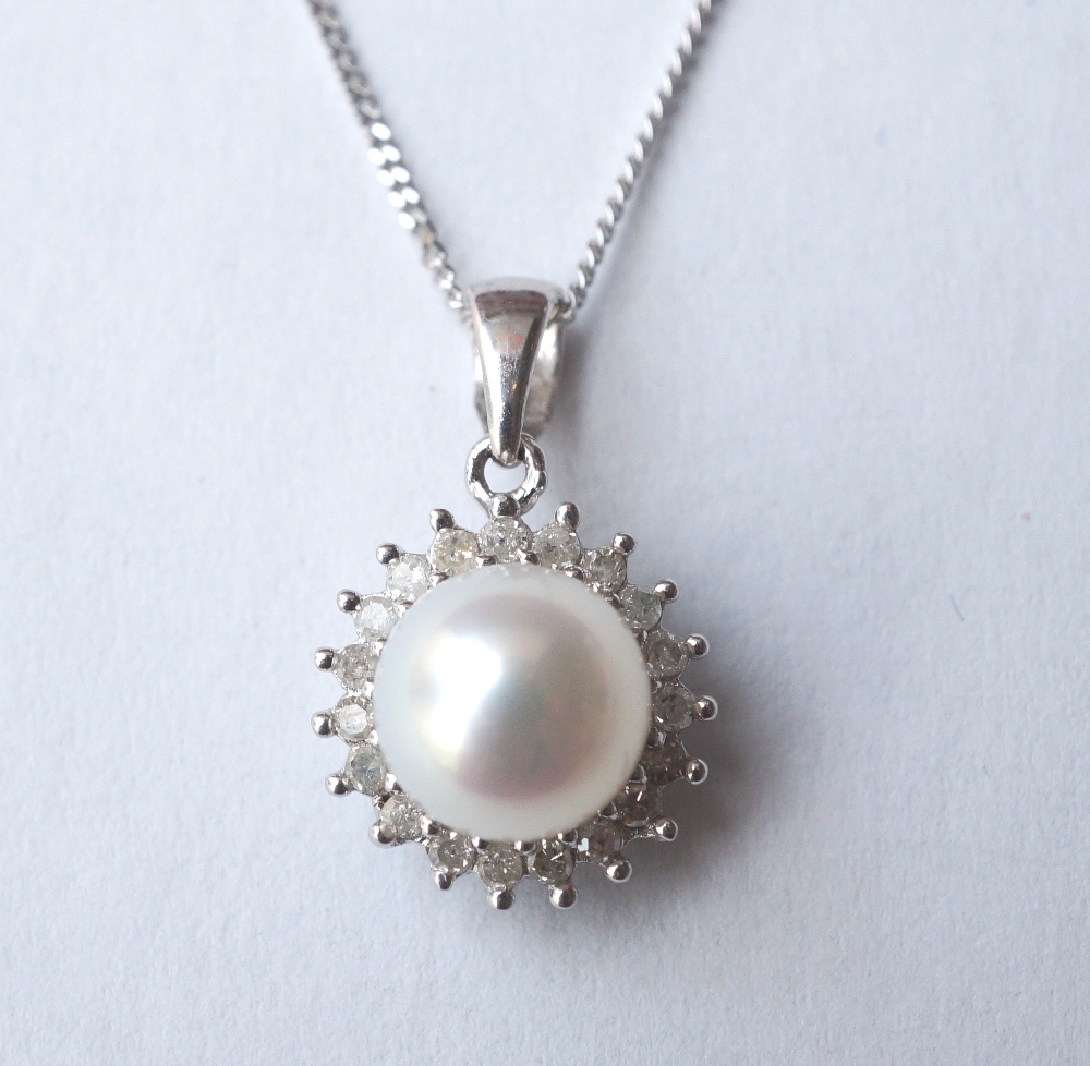 PEARL AND DIAMOND CLUSTER PENDANT
the central pearl in diamond surround, in nine carat white gold